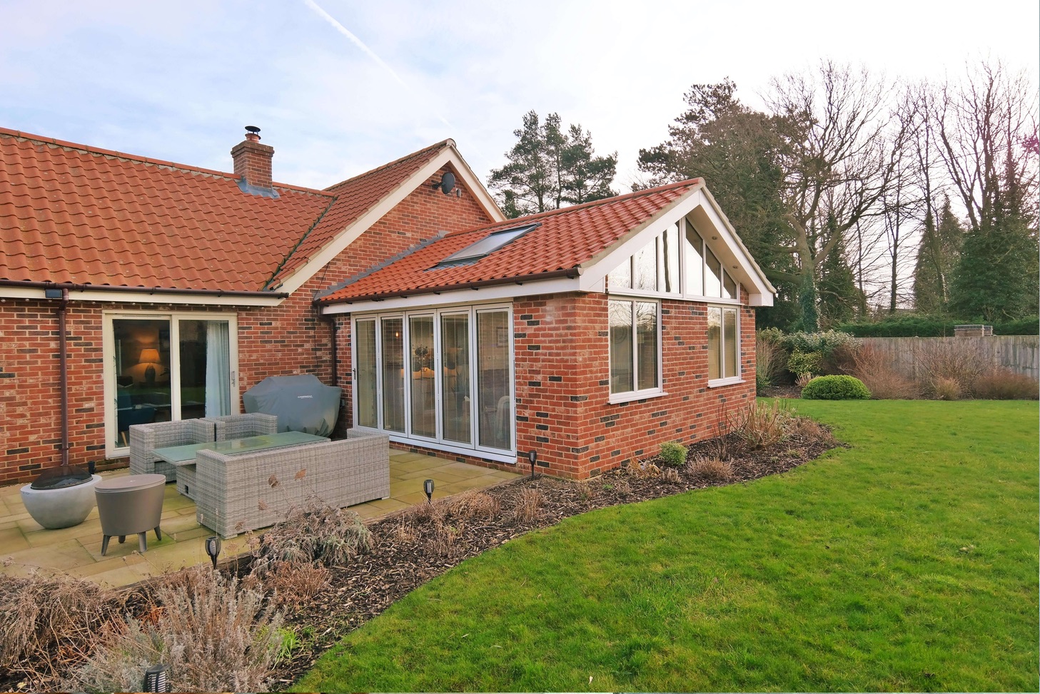 How do Garden Rooms and Orangeries keep a steady temperature during changing weather conditions?